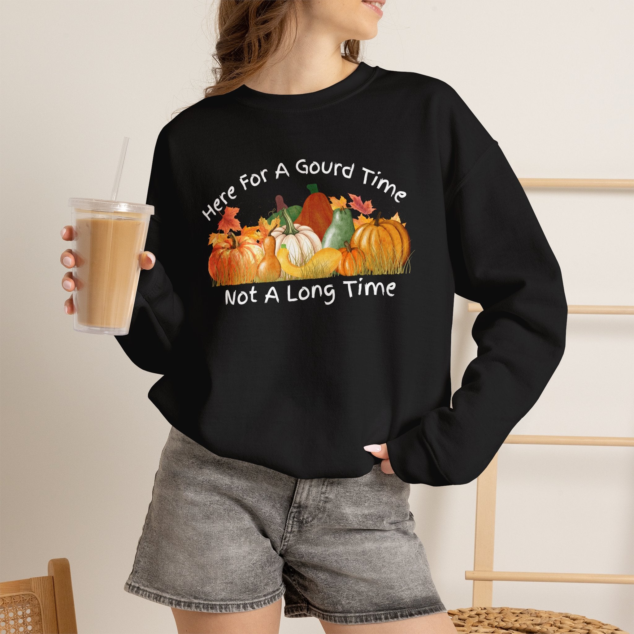 Here for a Gourd Time Not a Long Time crewneck sweatshirt — hand-drawn pumpkin cluster design in warm fall colors on a dark unisex crew, front view