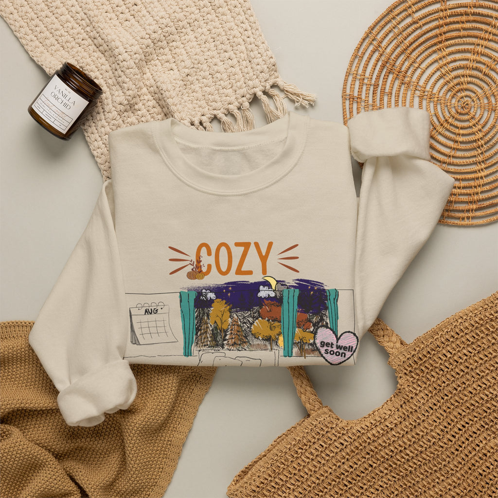 Cozy Within Reason fall crewneck by HKitty Enterprises, a funny autumn bedroom scene with a sleeping cat, a nighttime fall window, and a dying plant getting a get well soon balloon