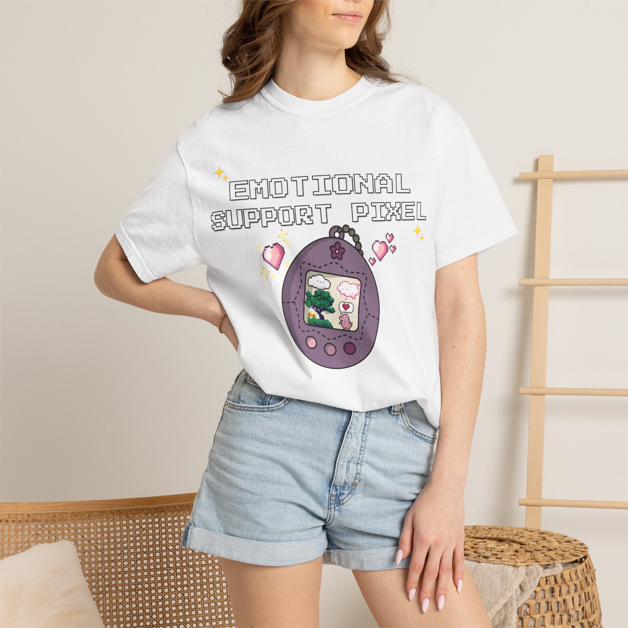 Black shirt with retro egg-shaped virtual pet device showing a pixel heart creature, captioned Emotional Support Pixel — front view